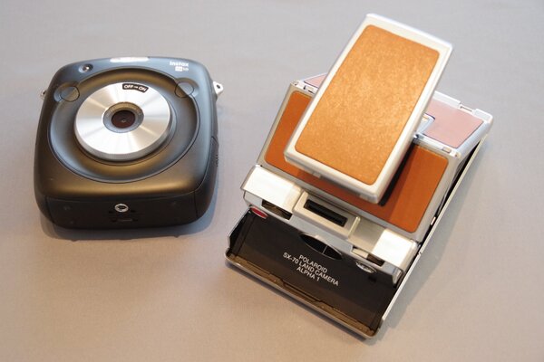 ランド博士が全知全能をつぎ込んで開発したSX70（右）に最も近づいたハイブリッドカメラが、45年後の今年登場したSQ 10なのかも知れない。LeicaのSOFORTも頑張ってほしいなぁ……＼(^o^)／