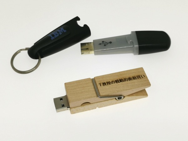 今から18年前に筆者も関わった容量8MBの“USBメモリーキー”（上：当時4800円）と、今回衝動買いした“洗濯ばさみ型USBメモリー”。容量はUSBメモリーキーの1000倍となる8GB（2680円）だ